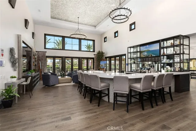 a living room with furniture large window and wooden floor