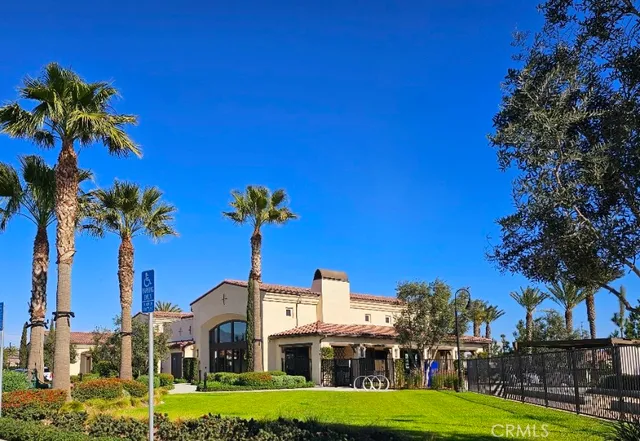 a front view of a building with palm trees