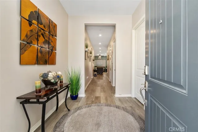 a large living room with stainless steel appliances kitchen island granite countertop furniture and a large window