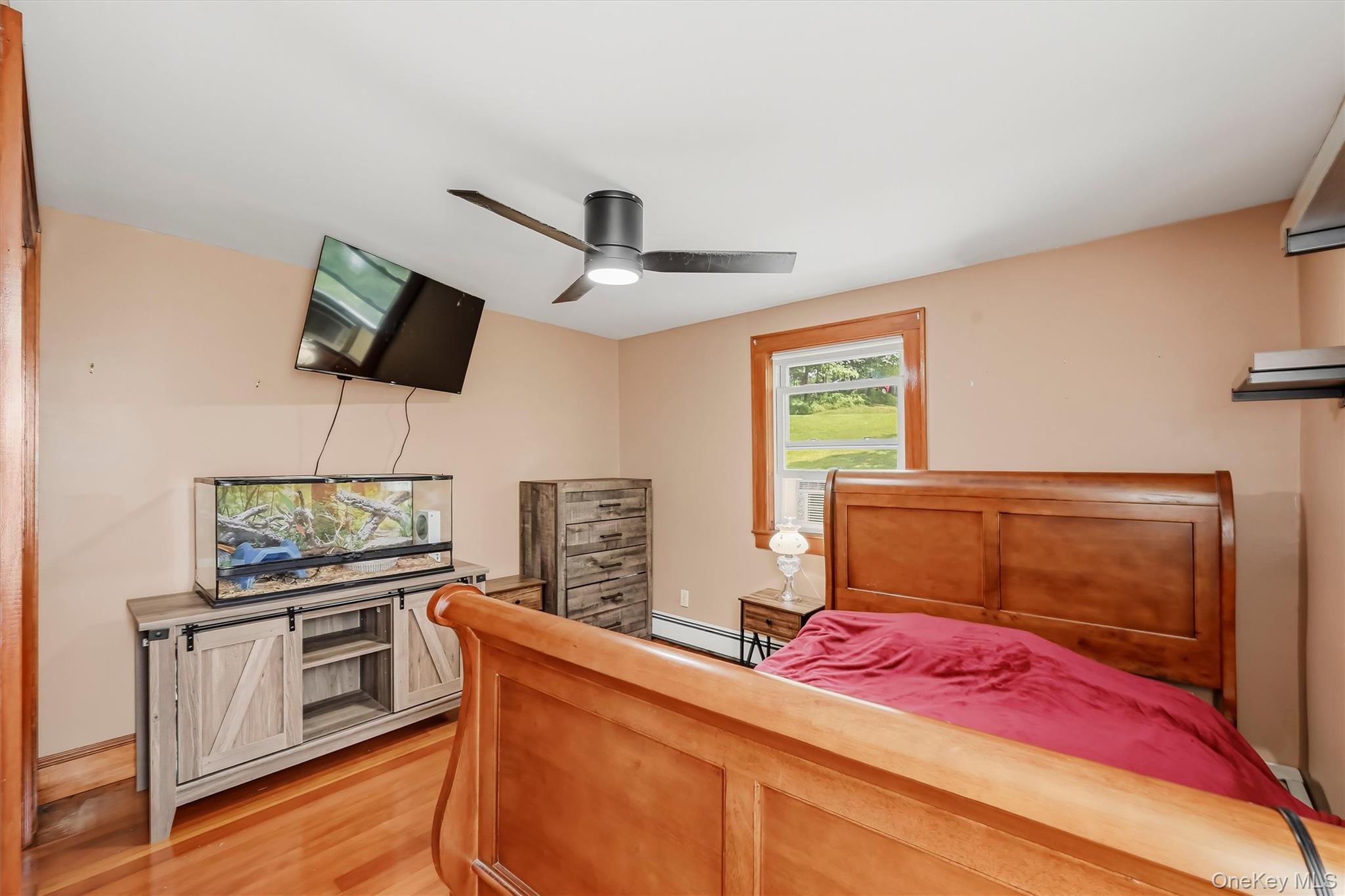 328 Big Island Road Florida, NY 10921 - Photo 18 of 40 Bedroom with hardwood floors, wood trim and ceiling fan.