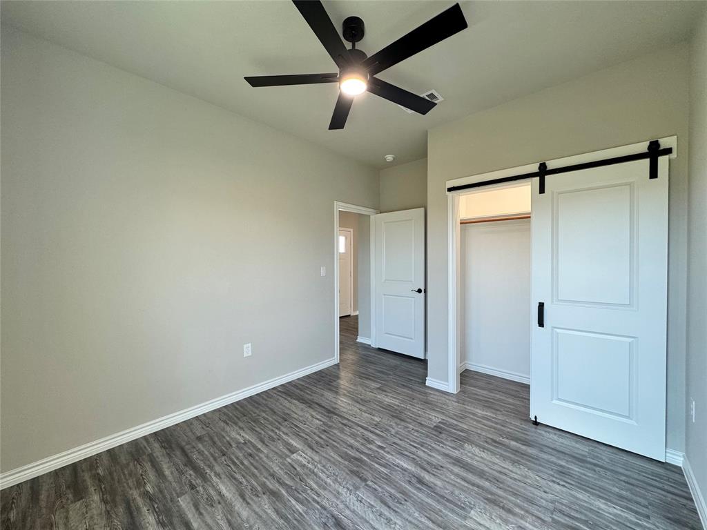 300 Rike Road Mabank, TX 75147 - Photo 16 of 18 an empty room with wooden floor and a ceiling fan
