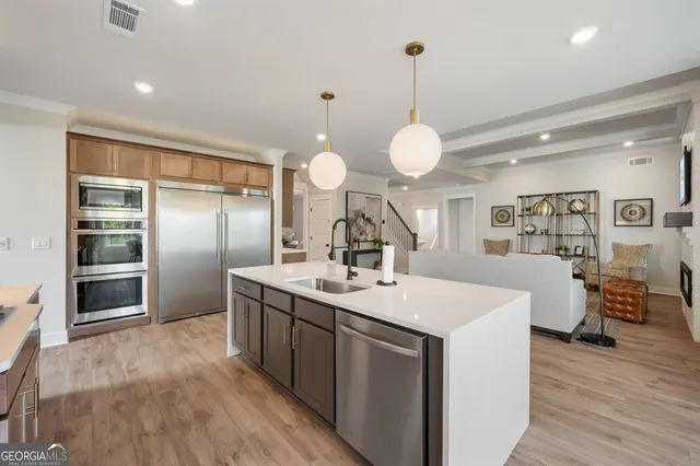 a room with a center island a chandelier and a window