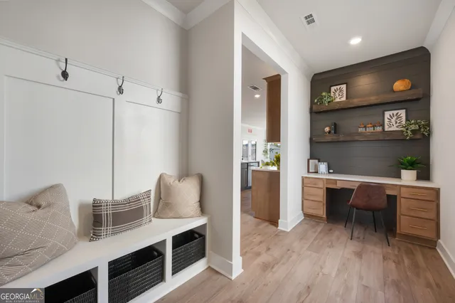 a bedroom with a large bed and a potted plant