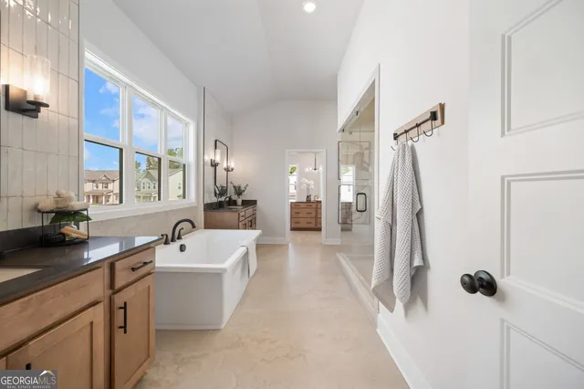 a spacious bedroom with a bed and painting on the wall