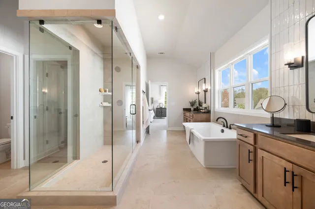 a dining room with furniture a chandelier and wooden floor