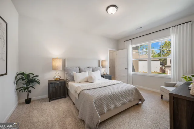 a view of a house with a yard and potted plants