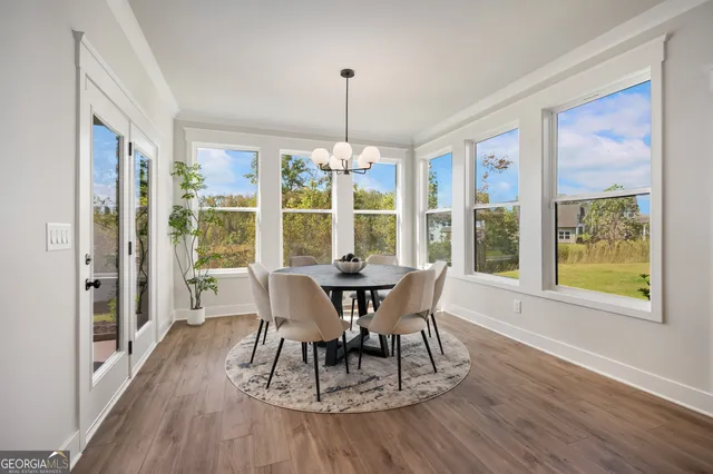 a view of a lake with a palm tree next to a road