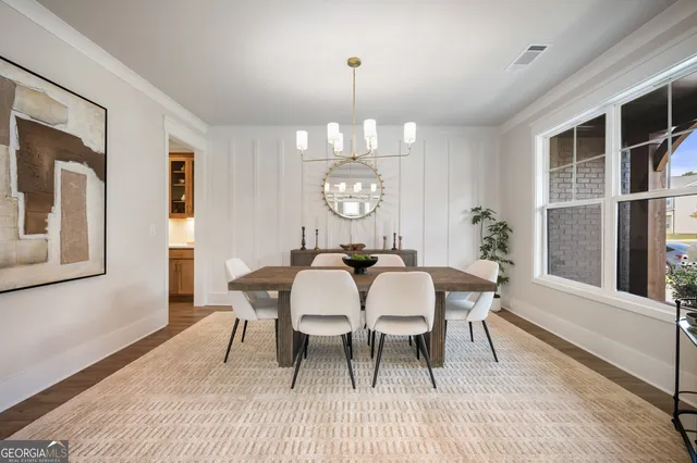 a front view of a building with cars parked