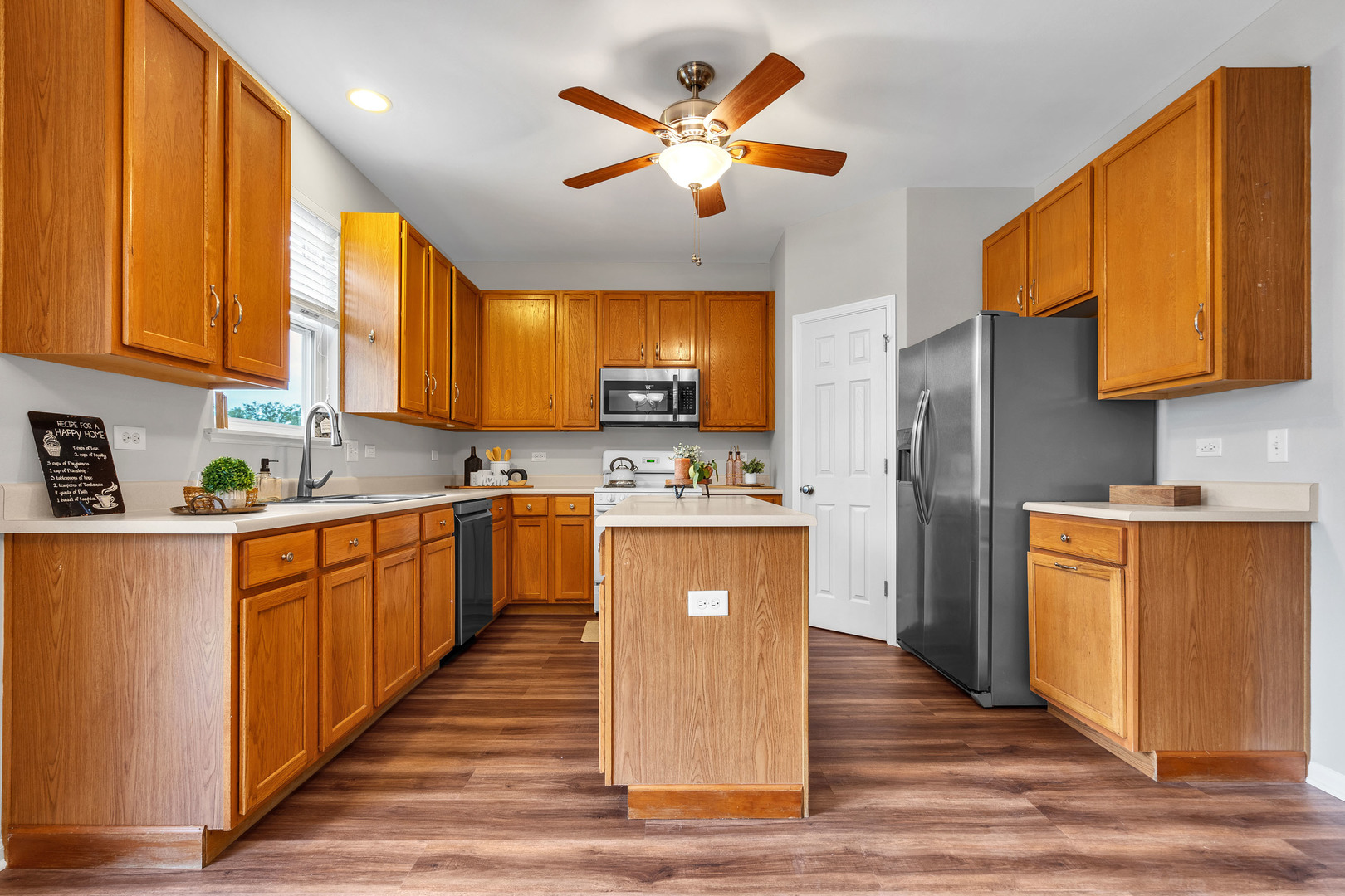 2513 Simon Drive Montgomery, IL 60538 - Photo 11 of 33 a kitchen with stainless steel appliances granite countertop wooden cabinets a refrigerator a sink a stove and a microwave