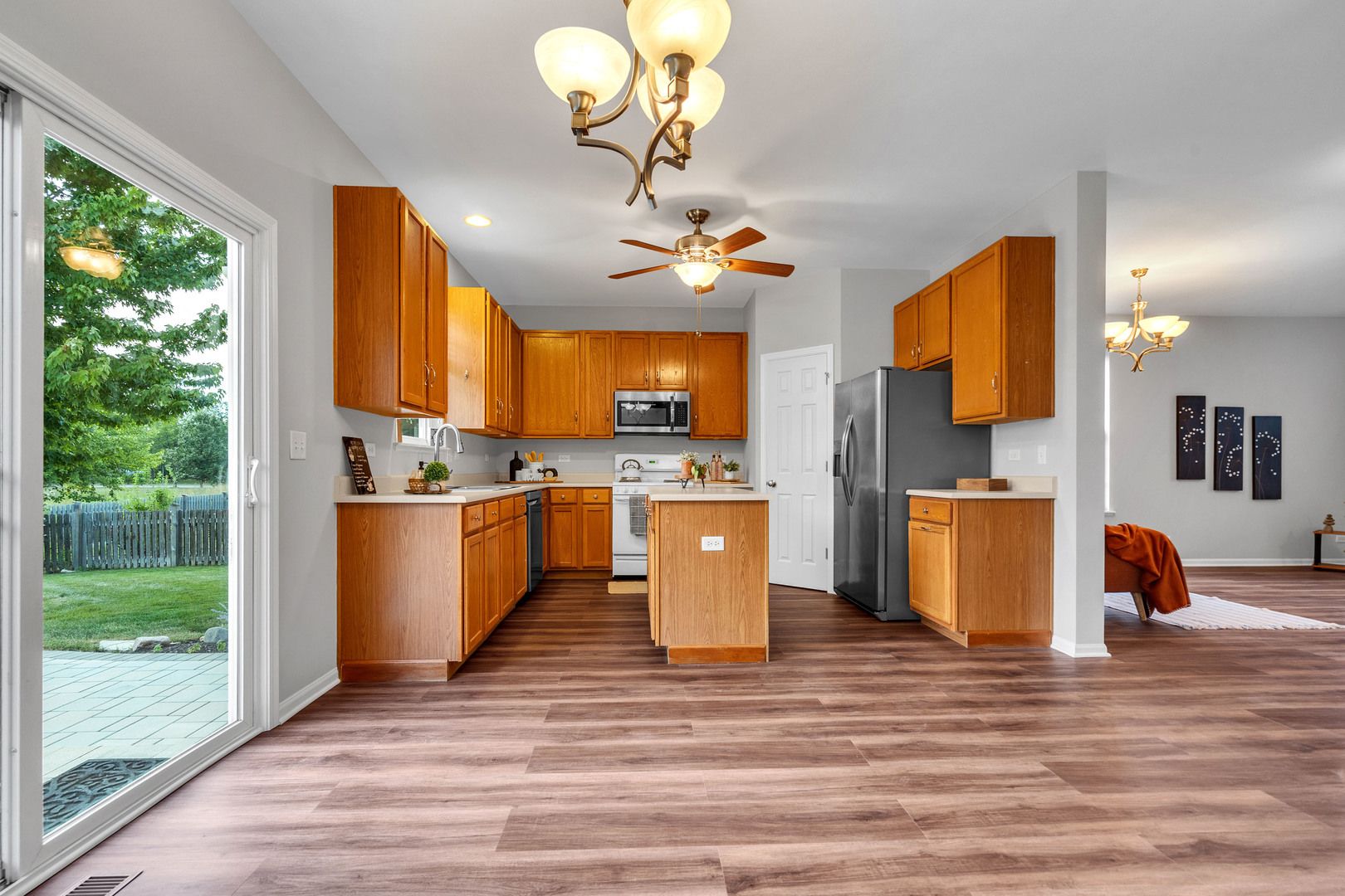 2513 Simon Drive Montgomery, IL 60538 - Photo 10 of 33 a dining hall with stainless steel appliances granite countertop a stove refrigerator sink and dishwasher with wooden floor