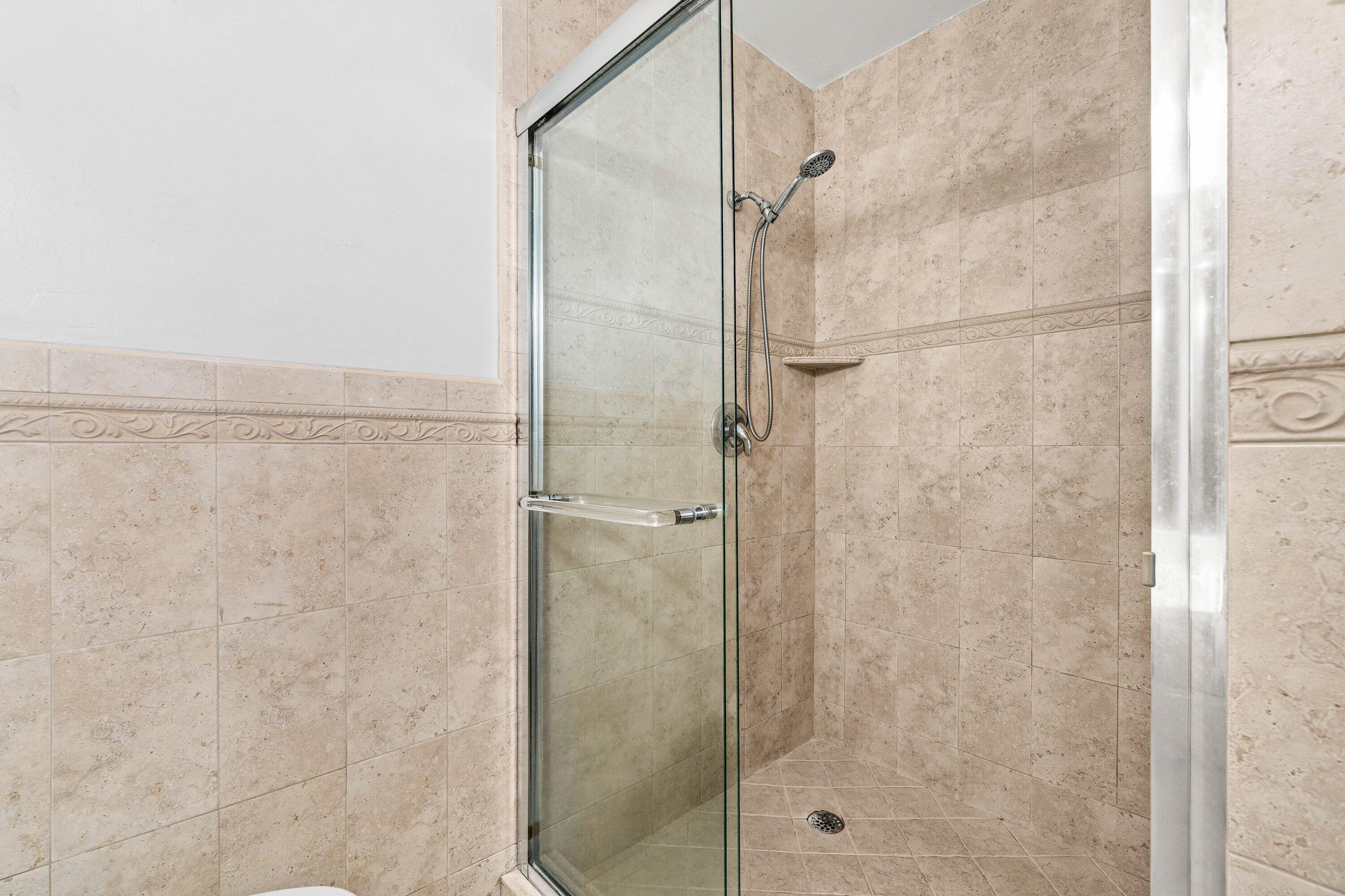 200 Southwest 7th Street, Unit 3 Boca Raton, FL 33432 - Photo 20 of 35 a bathroom with a glass shower door