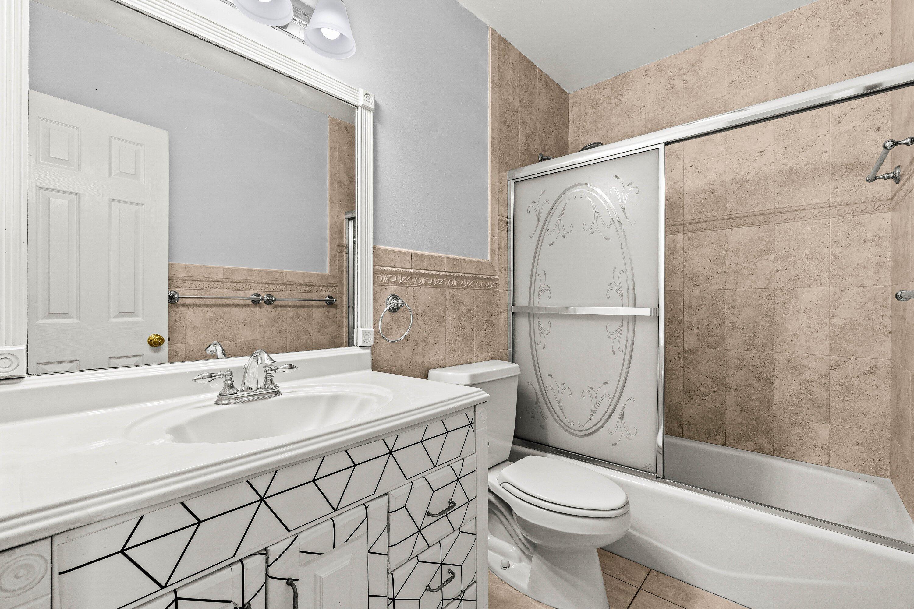 200 Southwest 7th Street, Unit 3 Boca Raton, FL 33432 - Photo 24 of 35 a bathroom with a sink toilet and shower