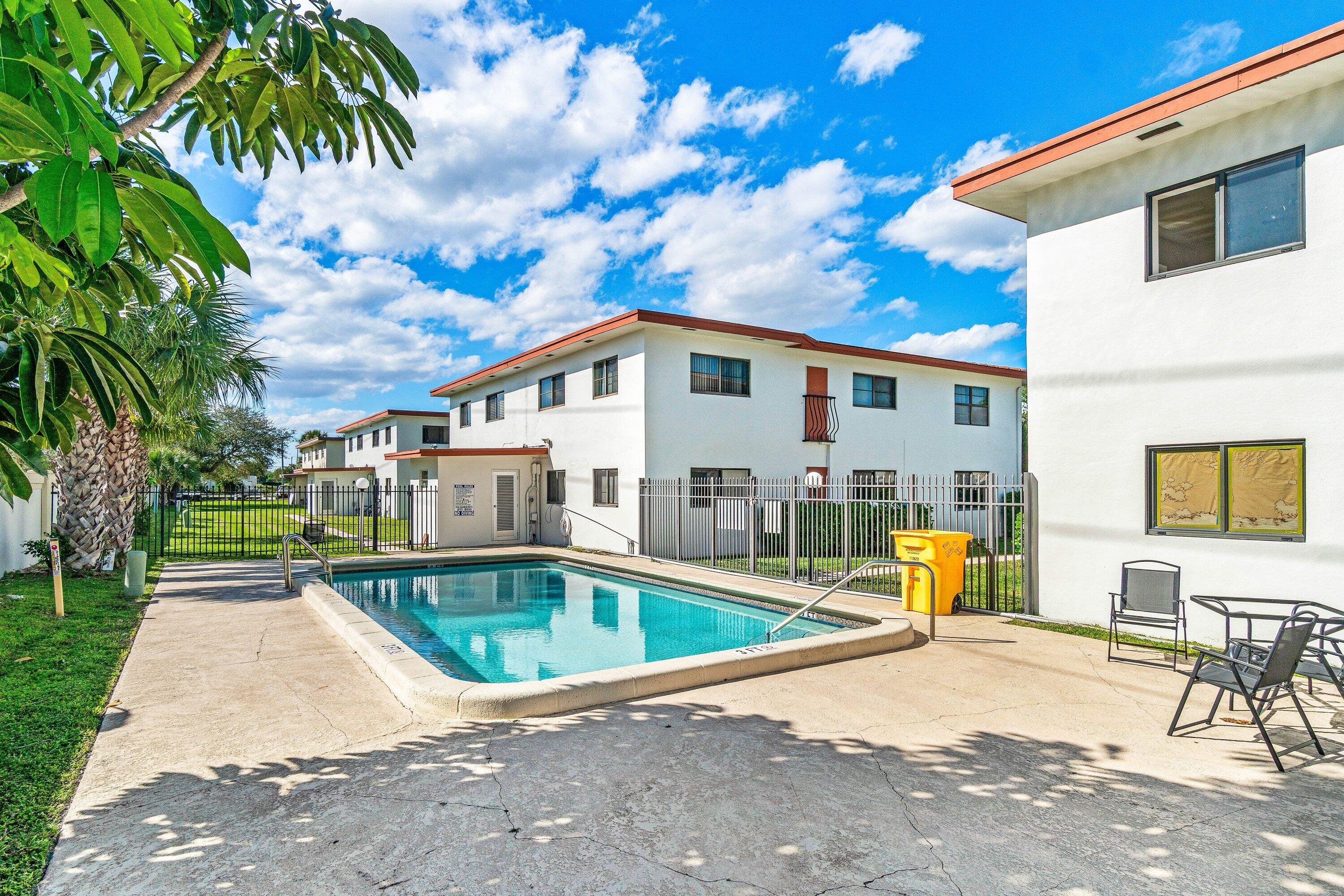 200 Southwest 7th Street, Unit 3 Boca Raton, FL 33432 - Photo 28 of 35 a front view of a house with swimming pool and furniture