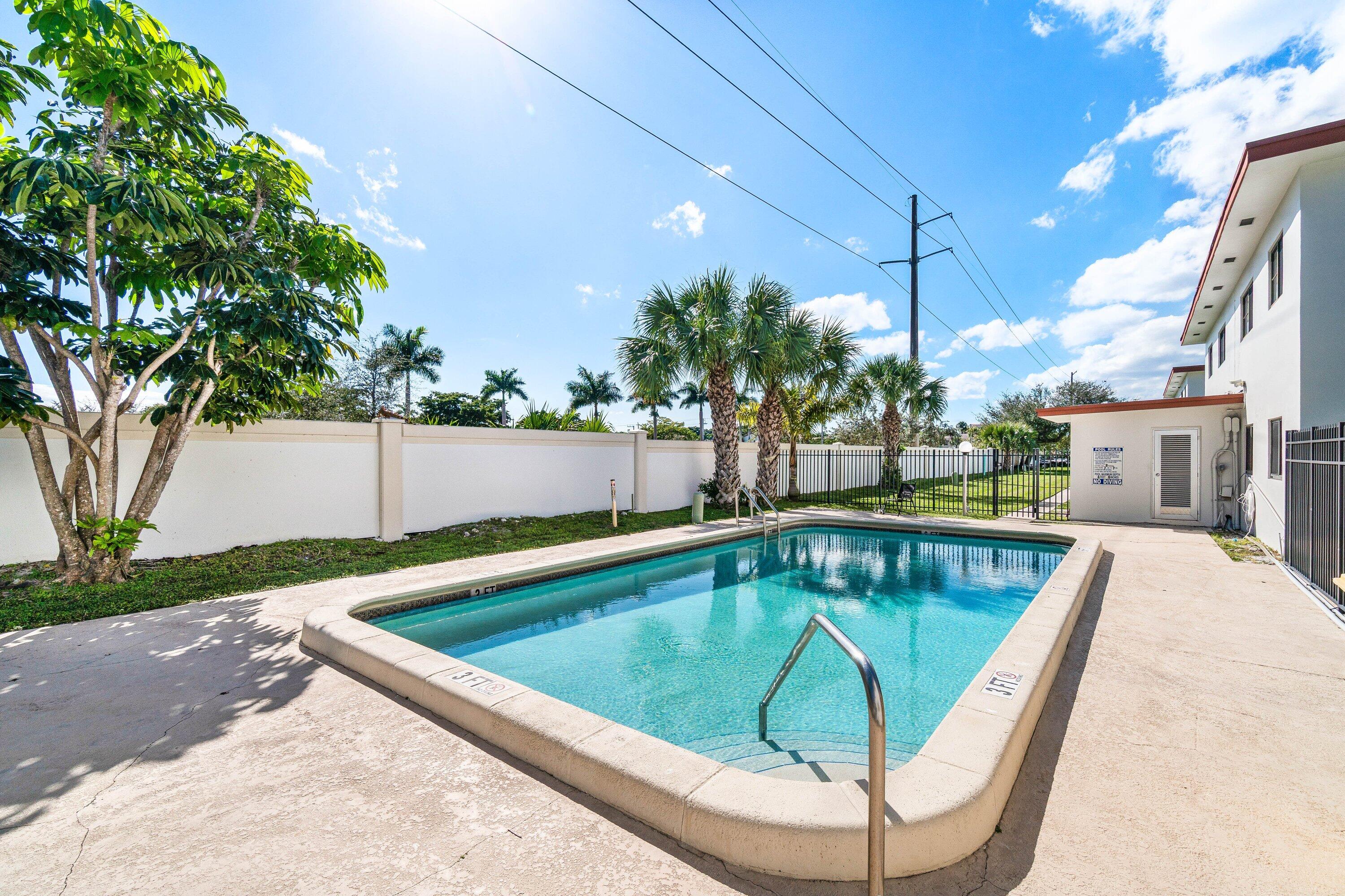 200 Southwest 7th Street, Unit 3 Boca Raton, FL 33432 - Photo 29 of 35 a view of a swimming pool with a patio and a yard