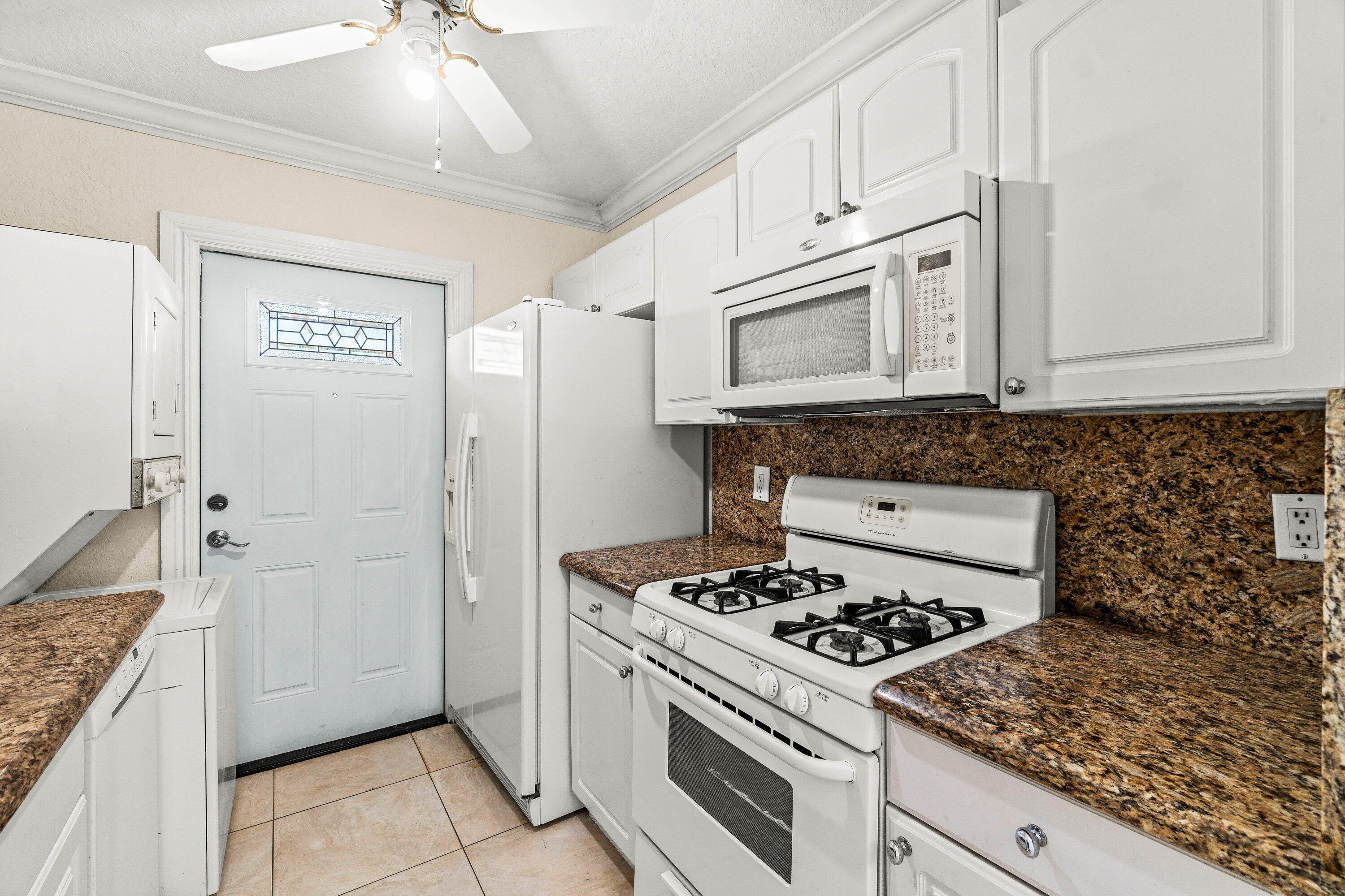 200 Southwest 7th Street, Unit 3 Boca Raton, FL 33432 - Photo 7 of 35 a kitchen with cabinets appliances and a counter space