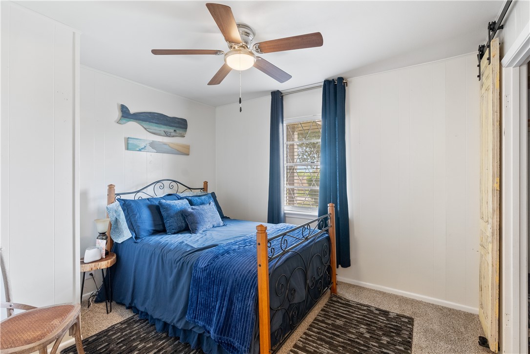 1204 Fannin Street George West, TX 78022 - Photo 11 of 24 a bedroom with a bed and a window