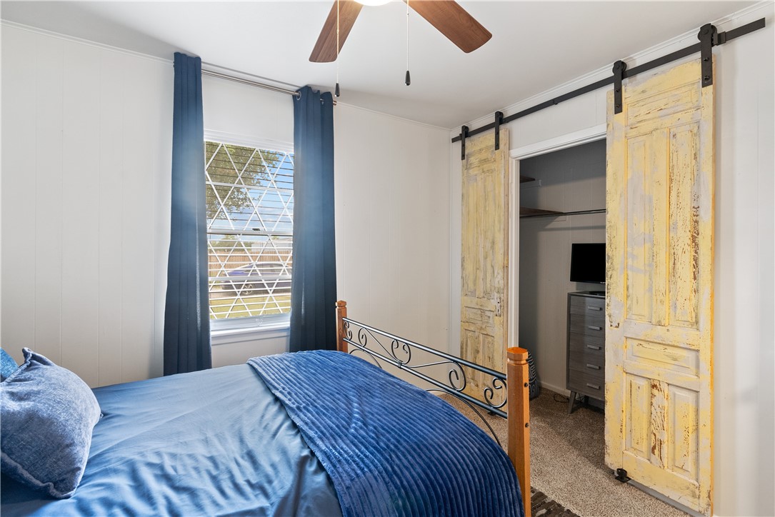 1204 Fannin Street George West, TX 78022 - Photo 12 of 24 a bedroom with a bed and a window