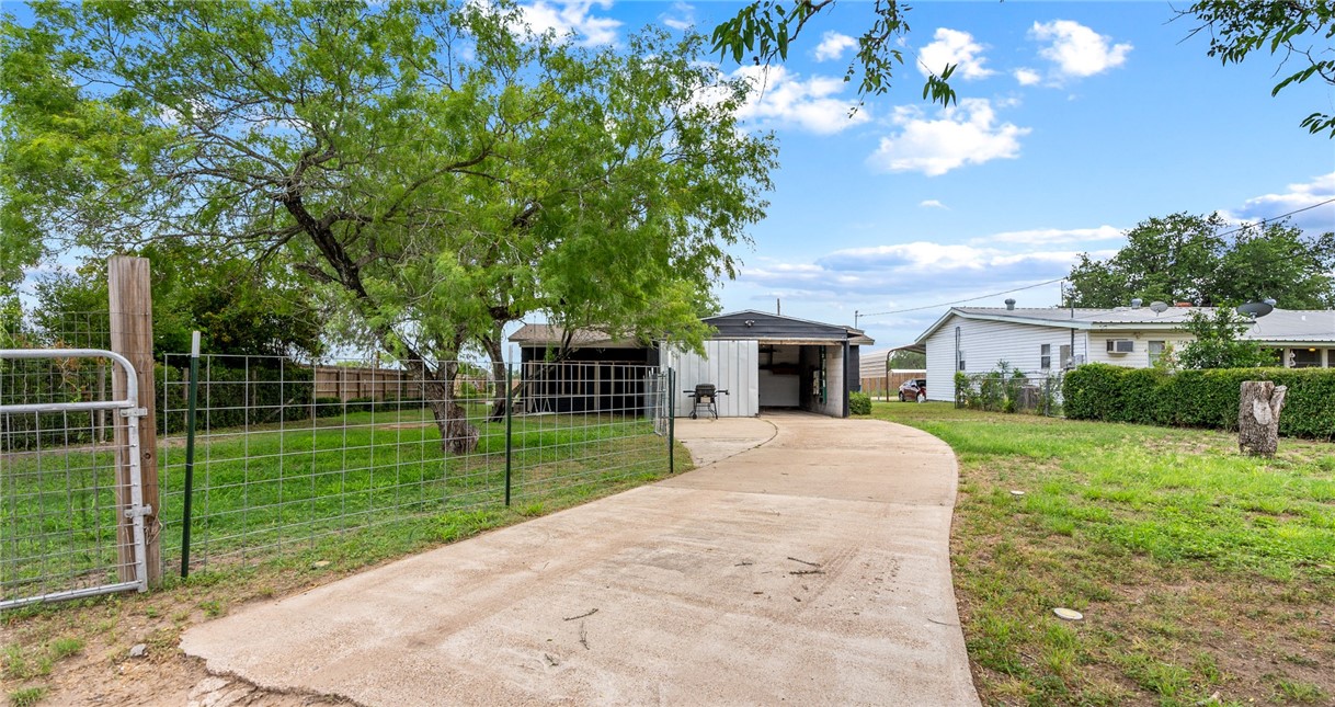 1204 Fannin Street George West, TX 78022 - Photo 22 of 24 a view of a house with a yard