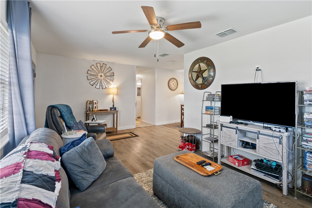 1204 Fannin Street George West, TX 78022 - Photo 5 of 24 a living room with furniture and a flat screen tv