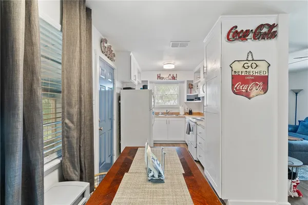 a kitchen with stainless steel appliances a stove a refrigerator and a window