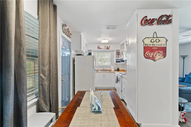 a kitchen with stainless steel appliances a stove a refrigerator and a window