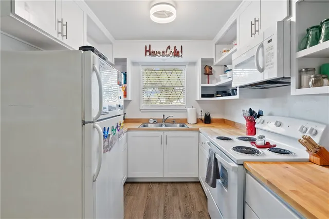 a kitchen with stainless steel appliances a sink and a refrigerator