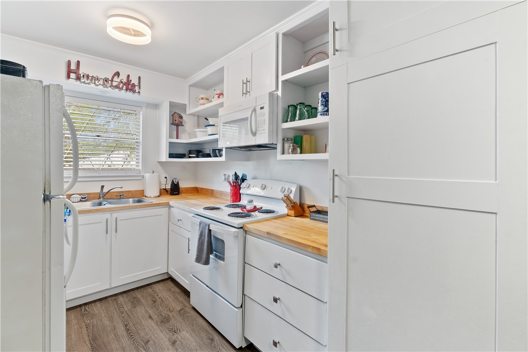 1204 Fannin Street George West, TX 78022 - Photo 9 of 24 a kitchen with stainless steel appliances a sink and a refrigerator