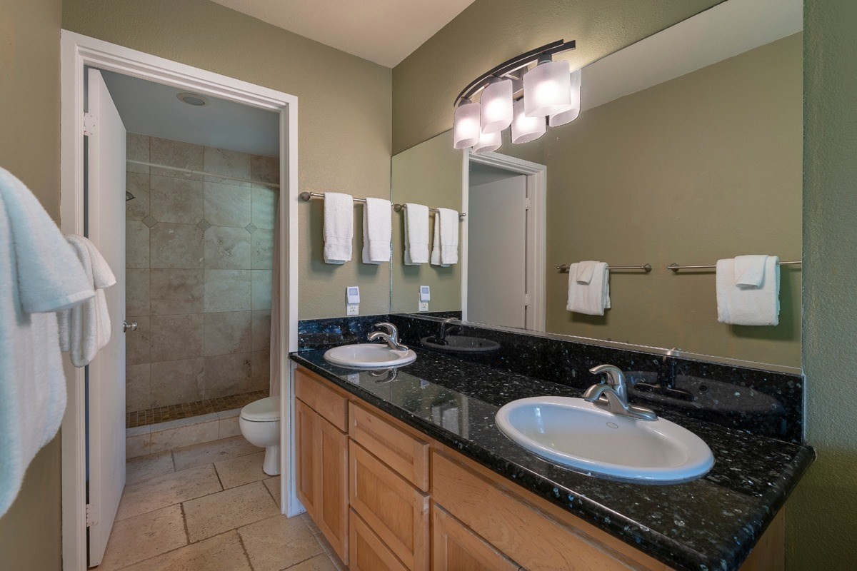 2415 Linaka Road Koloa, HI 96756 - Photo 18 of 25 a bathroom with a sink double vanity and a mirror