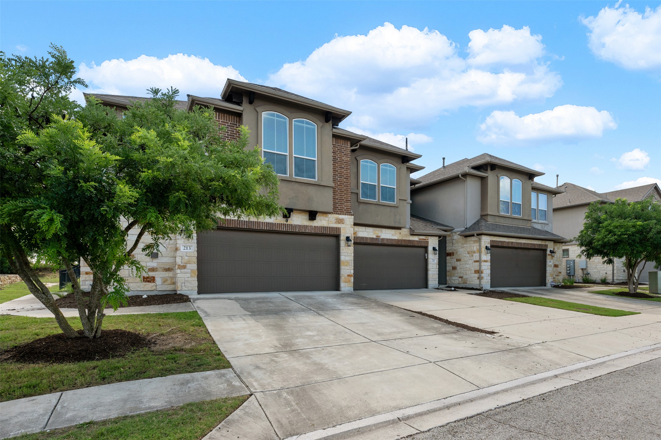 211 Parable Cove Pflugerville, TX 78660 - Photo 1 of 40 Modern townhome exterior featuring stone and stucco finishes