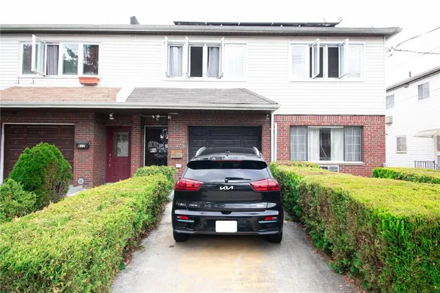a car parked in front of white house