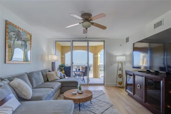 a living room with furniture a window and a dining table