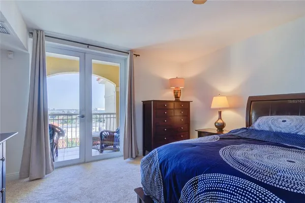 a bedroom with a bed and glass door