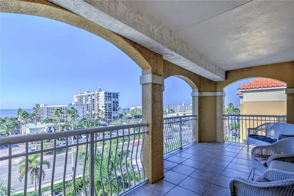 a view of a balcony with furniture and a floor to ceiling window