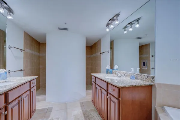 a bathroom with a granite countertop sink a vanity and a large mirror