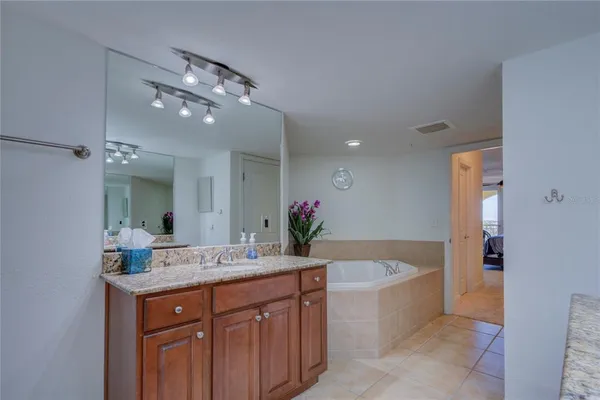 a bathroom with a bathtub sink and mirror