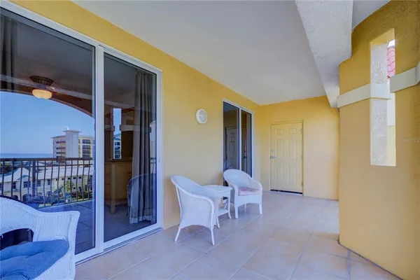 a view of a lobby with a chair and a potted plant