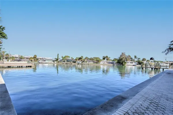 a view of a lake with boats and trees in the background