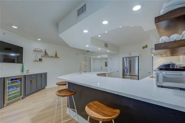 a kitchen with stainless steel appliances granite countertop a sink and a stove