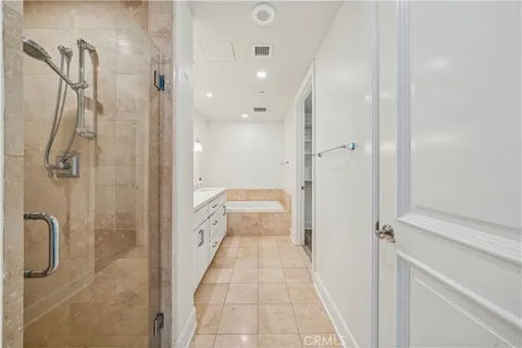 a bathroom with a double vanity sink a toilet and shower