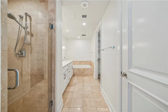 a bathroom with a double vanity sink a toilet and shower