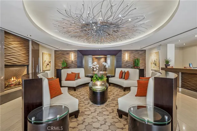 a living room with furniture a chandelier and a dining table