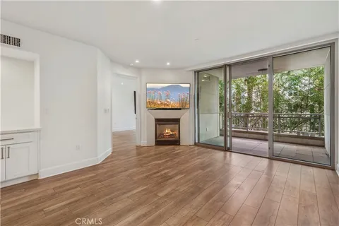 a view of a room with wooden floor and fireplace