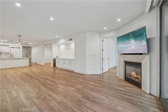 a view of empty room with wooden floor and fireplace