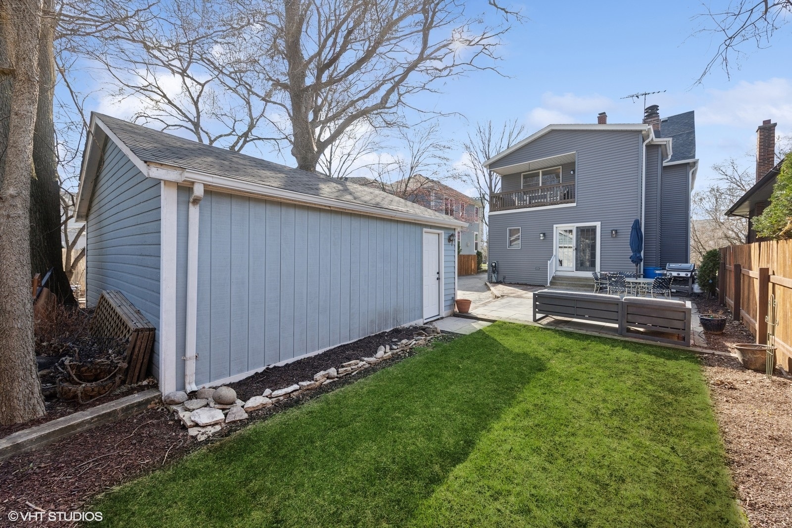 208 Fairbank Road Riverside, IL 60546 - Photo 25 of 29 a backyard of a house with wooden fence and large trees