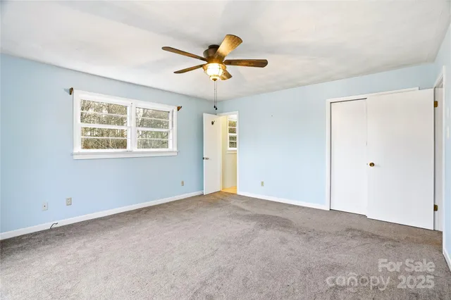 a bathroom with a granite countertop toilet a sink and shower