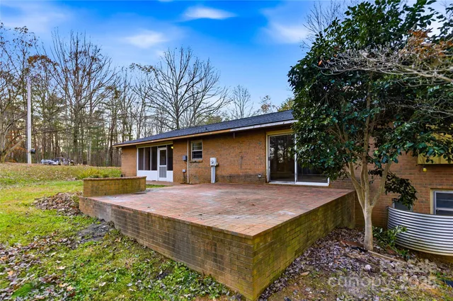 a red brick house with trees in front of it