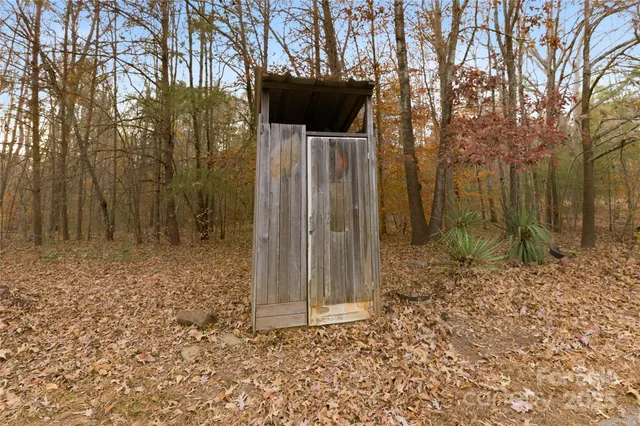 a view of a yard covered with snow in front of house