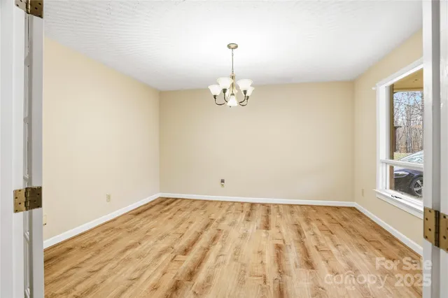 a kitchen with stainless steel appliances granite countertop a refrigerator a sink dishwasher a stove and a refrigerator with wooden floor