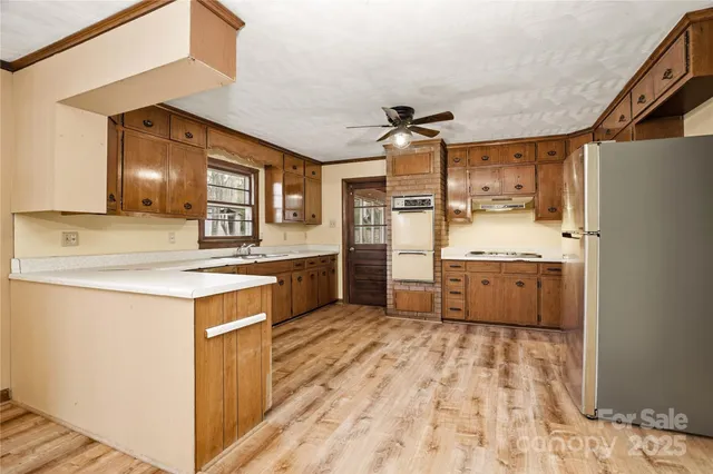 a kitchen with stainless steel appliances granite countertop a sink and cabinets