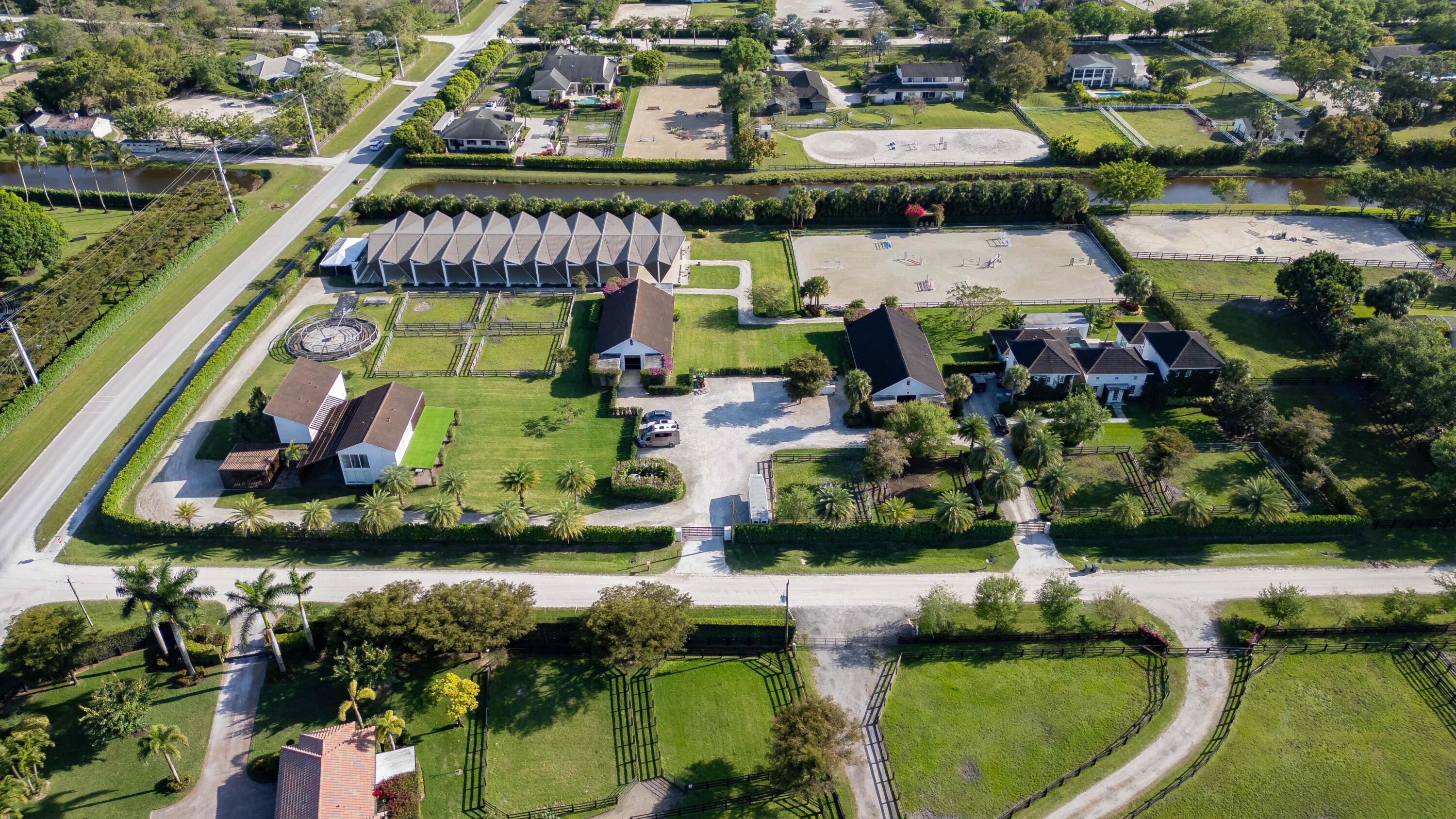 an aerial view of residential houses with outdoor space and swimming pool